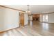 Living room with brick fireplace and plank flooring that opens to other rooms at 452 Hightower Ridge Rd, Covington, GA 30014