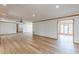 Open-concept living room with hardwood floors and neutral paint, bathed in natural light at 452 Hightower Ridge Rd, Covington, GA 30014