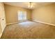 A cozy bedroom featuring neutral paint and carpet and lots of natural light at 512 Clearwater Dr, Mcdonough, GA 30252