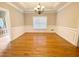 Traditional dining room with hardwood floors, wainscoting, and a view of a chandelier at 512 Clearwater Dr, Mcdonough, GA 30252