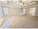 Bright living room with large windows, plush carpeting, and elegant ceiling trim at 512 Clearwater Dr, Mcdonough, GA 30252