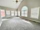 Open living room with large windows, a fan, and vaulted ceilings at 512 Clearwater Dr, Mcdonough, GA 30252