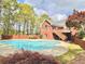 Inviting backyard featuring a large in-ground pool, patio, deck and lush landscaping at 512 Clearwater Dr, Mcdonough, GA 30252