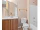 Bathroom featuring wood vanity, toilet, mirror, shower and bathtub at 6422 Phillips Ct, Lithonia, GA 30058
