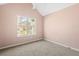 Neutral bedroom features a large window and a ceiling fan at 6422 Phillips Ct, Lithonia, GA 30058