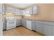Well-lit kitchen features granite counters, and modern white appliances at 6422 Phillips Ct, Lithonia, GA 30058