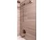 Close up of updated shower with bronze fixtures and elegant tiled walls at 6851 Roswell Rd # A-12, Atlanta, GA 30328