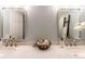 Double sink bathroom vanity with granite counters, orchids, and decorative bowl at 6851 Roswell Rd # A-12, Atlanta, GA 30328
