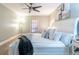 Bedroom features white furniture, a ceiling fan, and a large window at 6851 Roswell Rd # A-12, Atlanta, GA 30328
