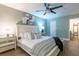 Bedroom with comfortable looking bed, fan, and neutral-colored walls with artwork at 6851 Roswell Rd # A-12, Atlanta, GA 30328