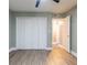 Spacious bedroom featuring hardwood floors, a ceiling fan and closet space at 6851 Roswell Rd # A-12, Atlanta, GA 30328