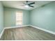 Light-filled bedroom with ceiling fan and blinds at 6851 Roswell Rd # A-12, Atlanta, GA 30328