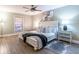Bedroom with modern ceiling fan, white furniture, and a zebra print rug at 6851 Roswell Rd # A-12, Atlanta, GA 30328