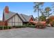 View of a clubhouse exterior with a charming portico and tree-lined parking at 6851 Roswell Rd # A-12, Atlanta, GA 30328
