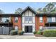 Brick apartment building featuring a front door and balconies with mature landscaping at 6851 Roswell Rd # A-12, Atlanta, GA 30328