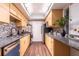 Galley kitchen featuring wood cabinets, stainless steel appliances, and granite countertops at 6851 Roswell Rd # A-12, Atlanta, GA 30328