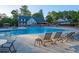 Community pool featuring lounge chairs, umbrellas, and mature trees in the background at 6851 Roswell Rd # A-12, Atlanta, GA 30328