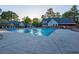 Community pool surrounded by lounge chairs, umbrellas and well-maintained landscaping at 6851 Roswell Rd # A-12, Atlanta, GA 30328