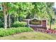 Foxcroft Condominium sign surrounded by manicured landscaping and mature trees at 6851 Roswell Rd # A-12, Atlanta, GA 30328
