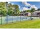 Outdoor tennis courts with net and fences, surrounded by mature trees and landscaping at 6851 Roswell Rd # A-12, Atlanta, GA 30328