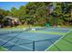 Well-maintained tennis courts enclosed by a fence, with landscaping and trees visible at 6851 Roswell Rd # A-12, Atlanta, GA 30328