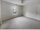 A bright bedroom features carpet flooring, a window and a closet at 7747 Rountree Xing, Riverdale, GA 30274