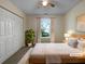 Cozy bedroom with natural light, plush carpet, and neutral tones, creating a serene retreat at 7747 Rountree Xing, Riverdale, GA 30274