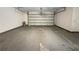 Spacious garage with an open garage door and concrete flooring at 7747 Rountree Xing, Riverdale, GA 30274