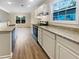 Modern kitchen features stainless steel appliances, granite countertops and white cabinets and an adjacent dining area at 7747 Rountree Xing, Riverdale, GA 30274