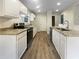 Well-lit kitchen featuring granite countertops, stainless steel appliances, and new LVP flooring at 7747 Rountree Xing, Riverdale, GA 30274