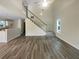 Open living room boasts soaring ceilings, wood flooring, a ceiling fan, and a staircase leading to the second floor at 7747 Rountree Xing, Riverdale, GA 30274