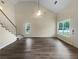 Bright living room featuring vaulted ceiling, ample natural light, and hard surface flooring at 7747 Rountree Xing, Riverdale, GA 30274
