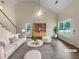 Bright living room featuring vaulted ceiling, ample natural light, and modern decor for a welcoming space at 7747 Rountree Xing, Riverdale, GA 30274