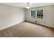 This spacious bedroom offers natural light with neutral walls and carpet at 2610 Betty Jean Dr, Jonesboro, GA 30236