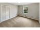 This carpeted bedroom has a closet, window and light colored walls at 2610 Betty Jean Dr, Jonesboro, GA 30236