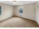 This bedroom has carpeted floors and neutral walls, with a window and closet at 2610 Betty Jean Dr, Jonesboro, GA 30236