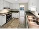 Well-lit kitchen with stainless steel appliances and ample cabinet space at 2610 Betty Jean Dr, Jonesboro, GA 30236