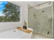 Luxurious bathroom featuring a freestanding tub, marble-tiled shower, gold fixtures, and a large window at 1598 Athens Ave, Atlanta, GA 30310