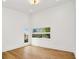 Bright bedroom featuring wood floors, white walls, recessed lighting, and windows with neighborhood views at 1598 Athens Ave, Atlanta, GA 30310