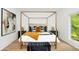 Bright bedroom with wood floors, large windows, stylish furnishings, and a four-poster bed at 1598 Athens Ave, Atlanta, GA 30310