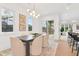 Bright dining area features a modern chandelier, stylish art, and sliding glass doors to the outdoors at 1598 Athens Ave, Atlanta, GA 30310