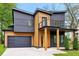View of a two-story house featuring wooden and grey siding, a balcony, and an attached two-car garage at 1598 Athens Ave, Atlanta, GA 30310