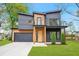 Striking modern home showcasing unique architecture, a two car garage, and a well-manicured lawn at 1598 Athens Ave, Atlanta, GA 30310