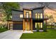 Modern two-story home featuring a 2-car garage, wood and gray siding, and a cozy front porch at 1598 Athens Ave, Atlanta, GA 30310