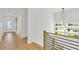 Bright hallway features hardwood floors, modern lighting, and stairway with black metal banisters at 1598 Athens Ave, Atlanta, GA 30310