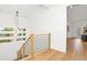 Hallway features hardwood floors and a modern staircase with black metal banisters at 1598 Athens Ave, Atlanta, GA 30310