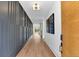 Elegant hallway with hardwood floors, modern light fixture, and decorative wall paneling at 1598 Athens Ave, Atlanta, GA 30310