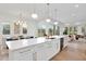 Bright, modern kitchen with a large island, and stainless steel appliances flows into the dining area at 1598 Athens Ave, Atlanta, GA 30310
