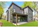 Modern home with a gray siding, glass balcony railing, and patio with outdoor seating area at 1598 Athens Ave, Atlanta, GA 30310