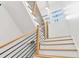 Stylish staircase with wooden handrail and black iron balusters leads to the upper level at 1598 Athens Ave, Atlanta, GA 30310
